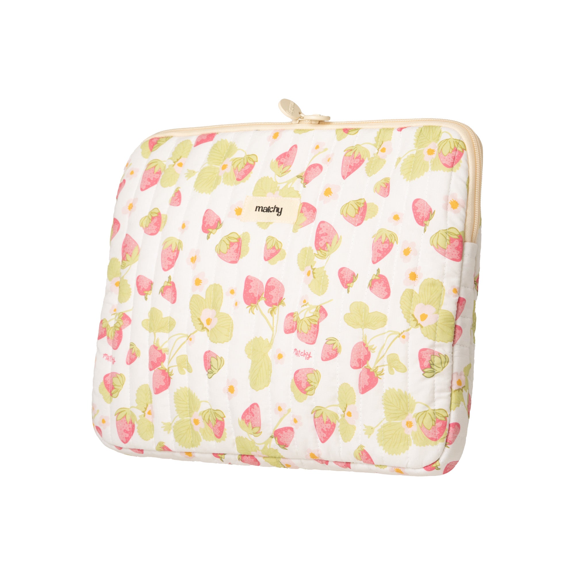 Angled view of a quilted strawberry print laptop sleeve with a cream zip and 'matchy' label. Matchy Sofia Laptop Sleeve for 13 to 15 inch laptops.