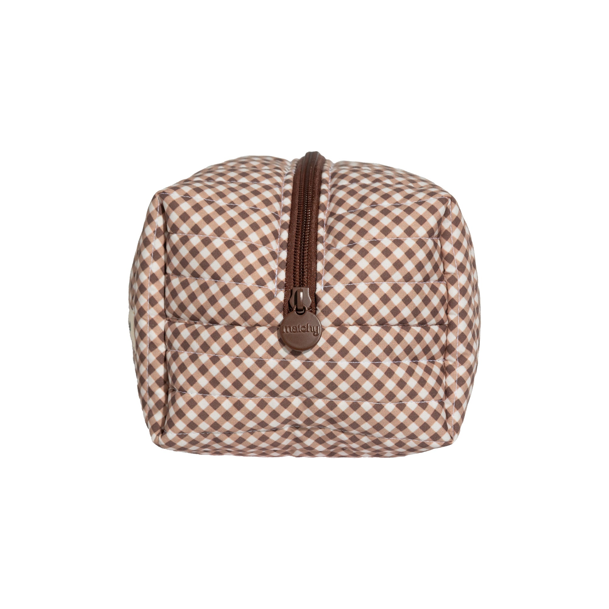 Side view of a brown and cream gingham carry-all bag showing the boxy shape and brown leather look pull tab. Matchy Chocolate Carry-All Bag, a quilted cotton toiletry and makeup bag.