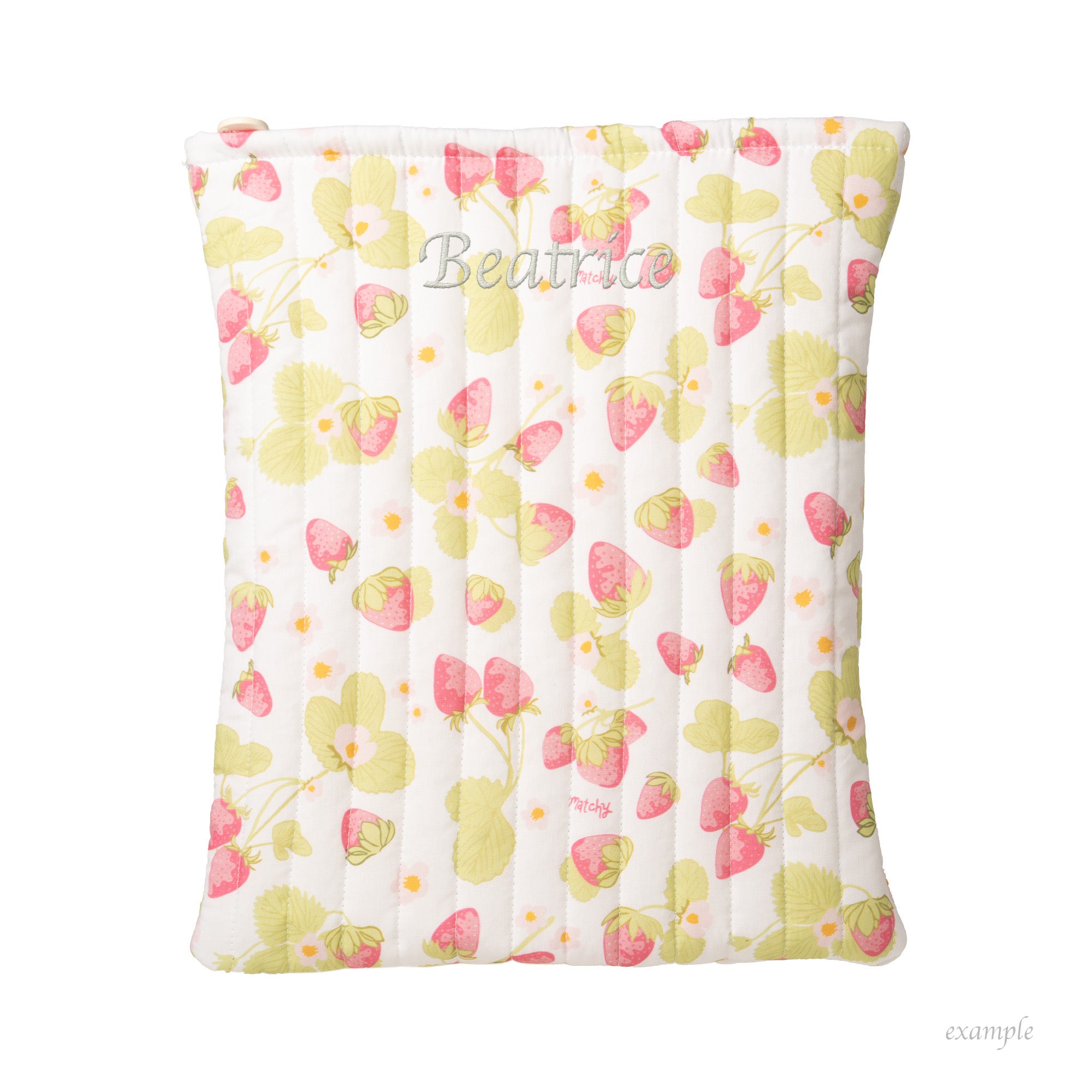 Strawberry and green leaf print quilted book sleeve with a name in script shown as an example of custom embroidery. Matchy Sofia Custom Embroidery Book Sleeve.